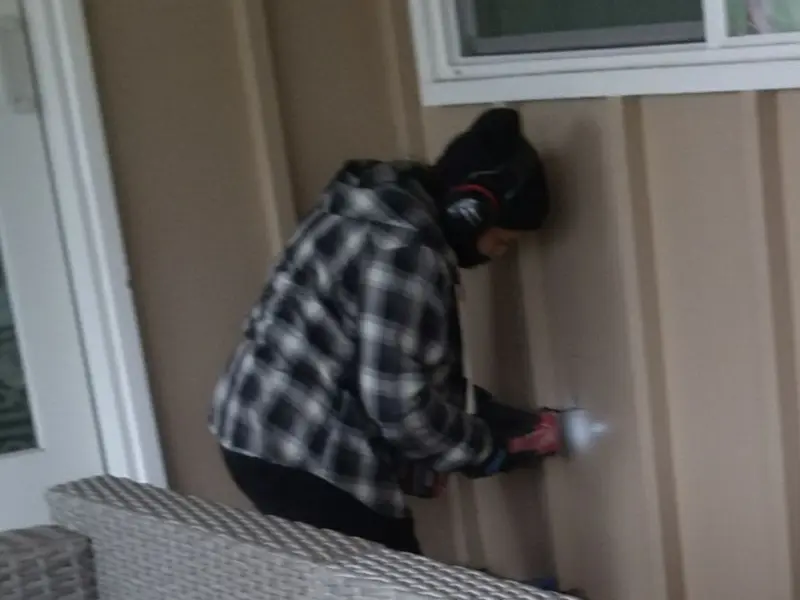 Professional electrician installing an exterior outlet in Blue Earth