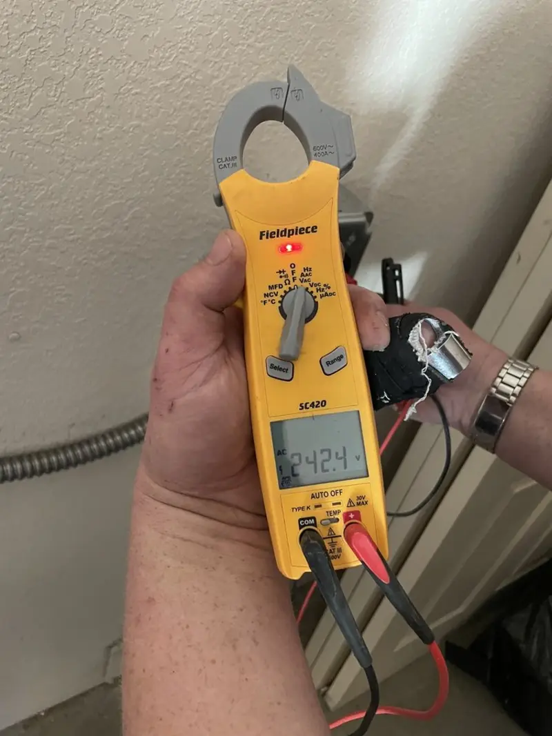 Voltage testing with clamp meter during Ceiling Fan Installation in Blue Earth